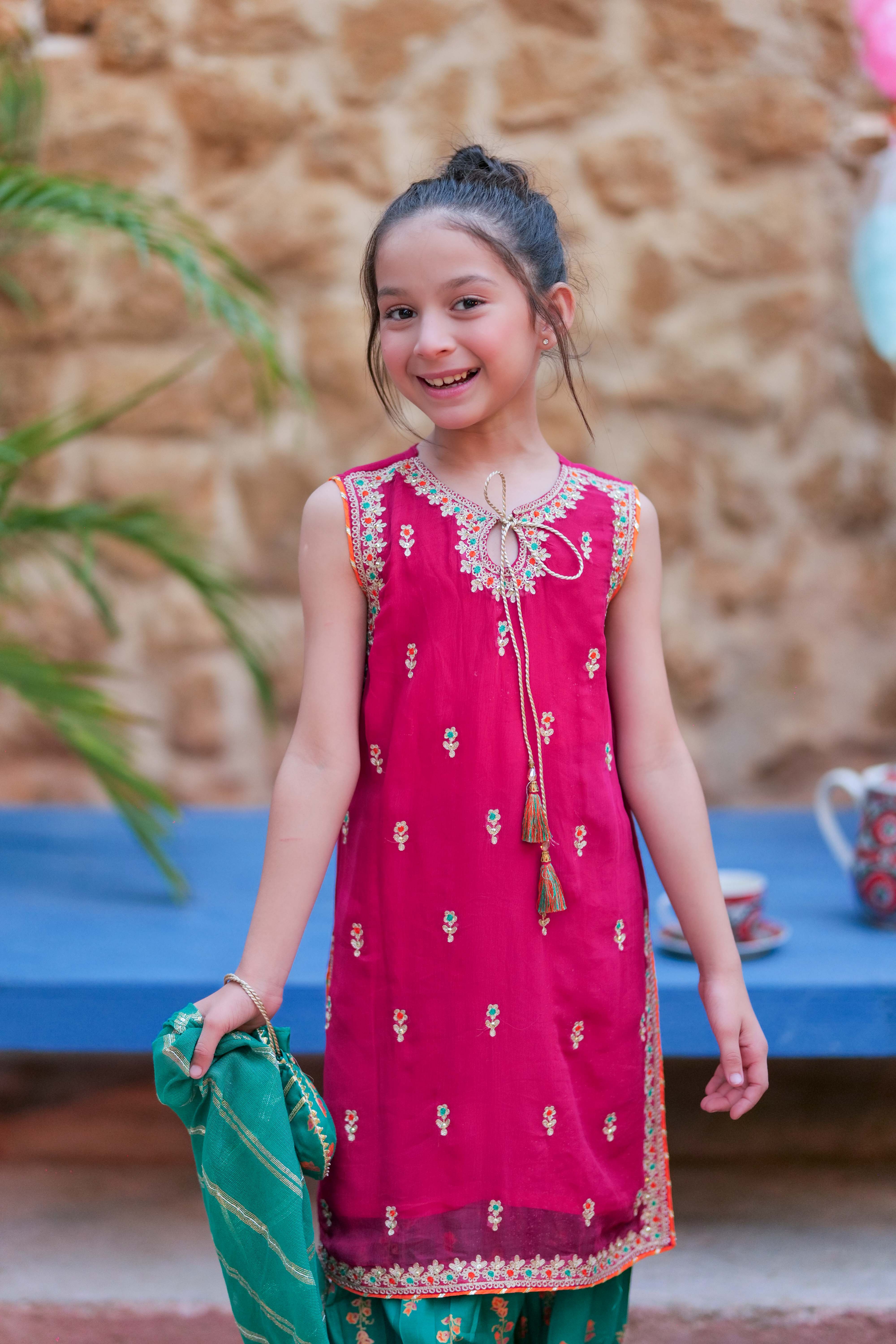 shocking pink and green dress Melody is a vibrant mint-green dress with hot pink floral print. It features beautiful sequin and bead work that adds a hint of sparkle, this dress combines style and elegance, bringing a